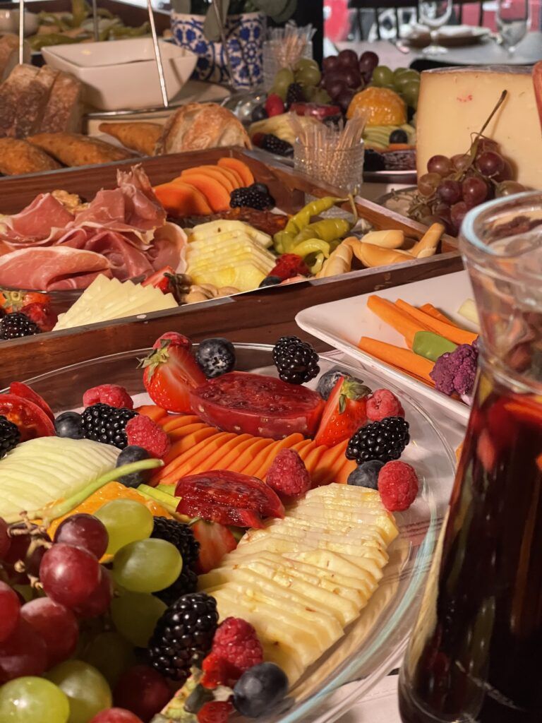 Beautiful grazing table decorated with flowers and fresh fruit for celebrations